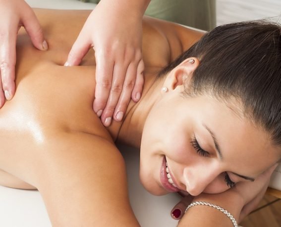 Beautiful smiling young woman getting a massage